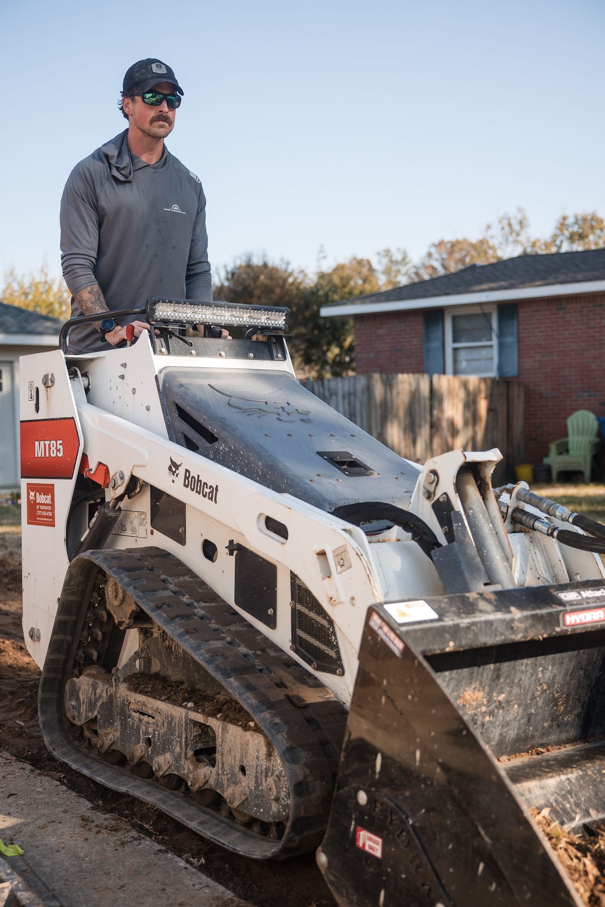 Harrison Davis on a mini track loader
